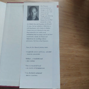 Book with a portrait and text on a wooden surface
