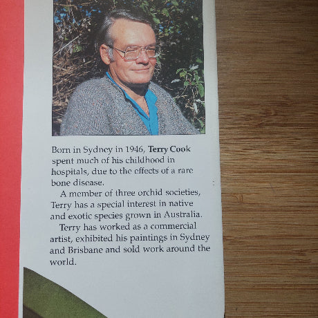 Book or magazine page with a portrait of a person and text on a wooden surface