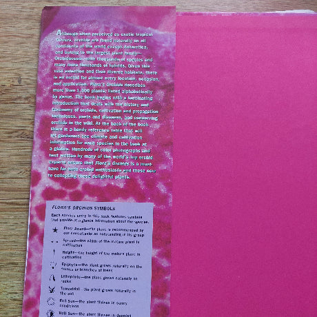 Pink book with text on a wooden surface