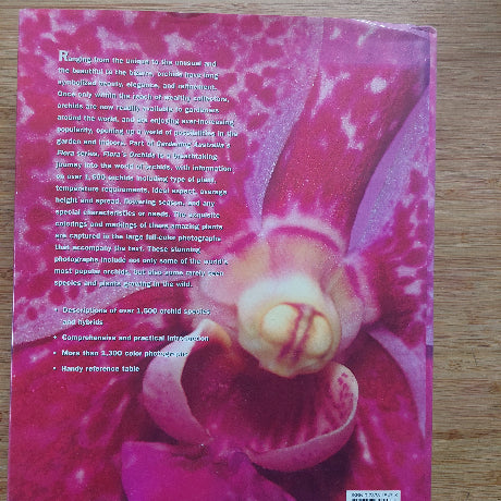 Book cover with a pink orchid on a wooden surface