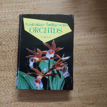 Book titled 'Australian Indigenous Orchids' on a wooden surface