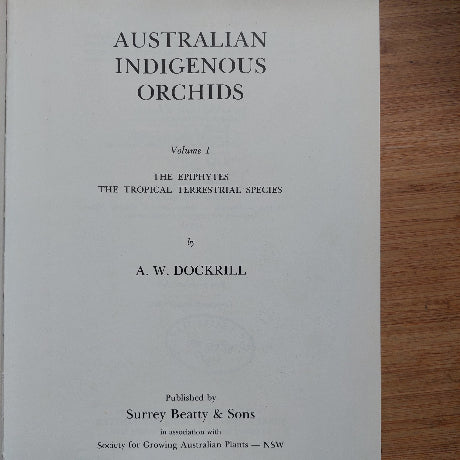 Book titled 'Australian Indigenous Orchids' by A.W. Dockrill on a wooden surface